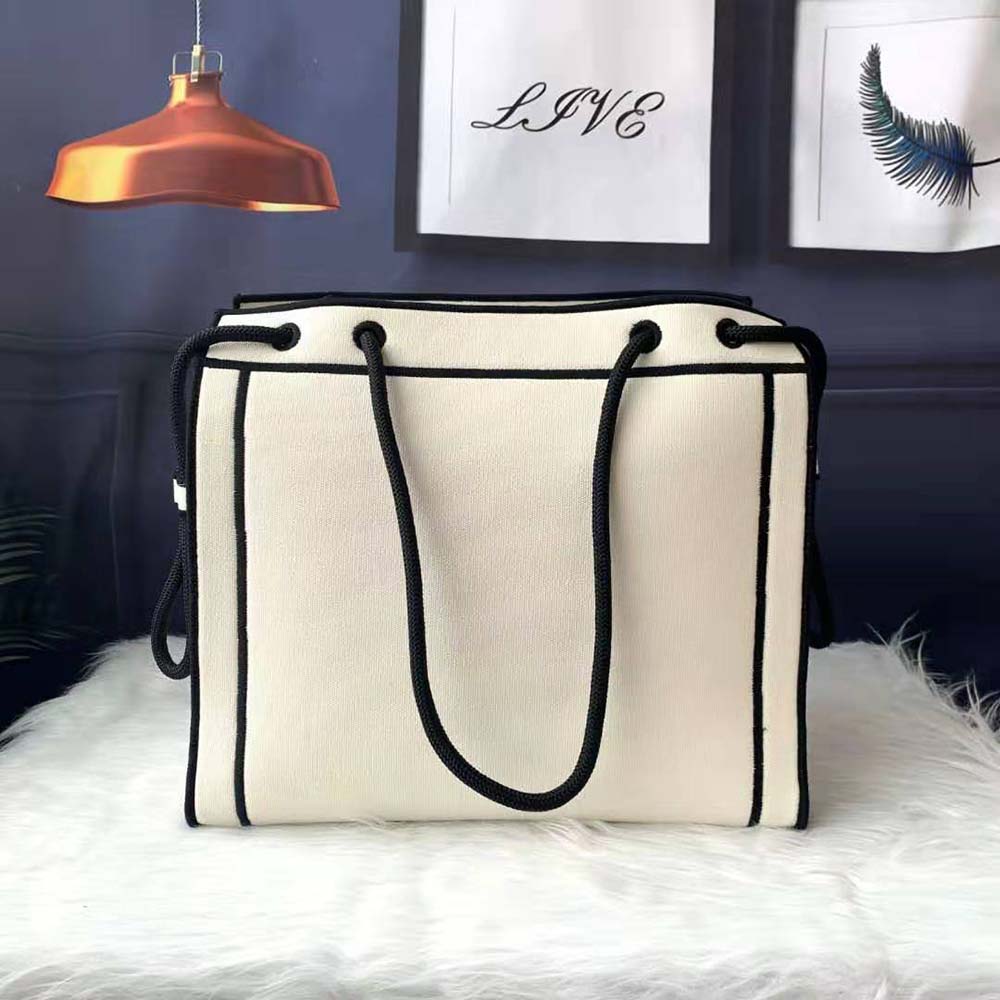 Side angle showcasing white undyed canvas texture and structured silhouette