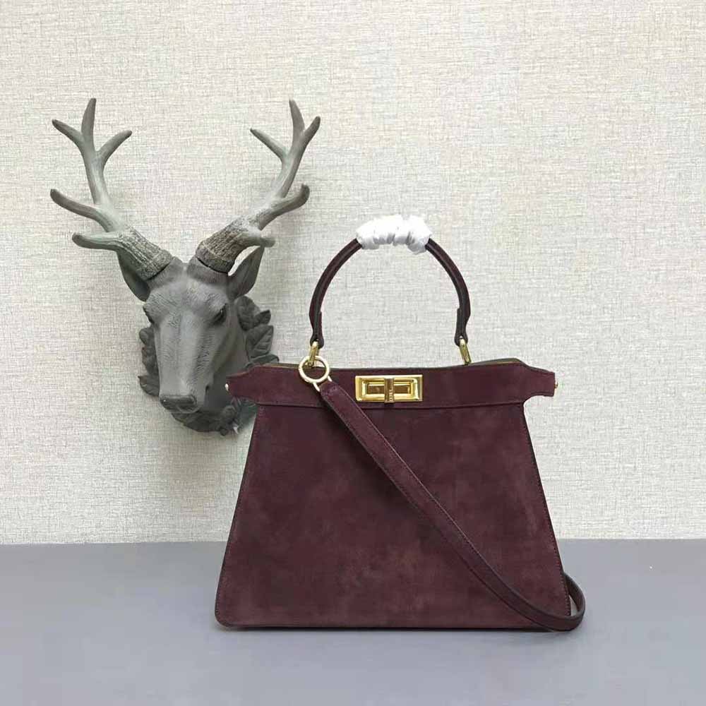 Side angle highlighting maroon suede and silhouette of Fendi Women Medium Peekaboo I See U Brown Suede Bag
