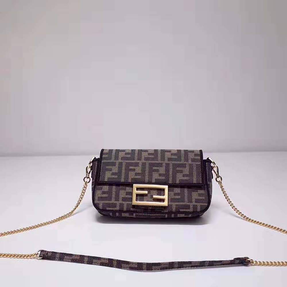 Close-up of gold-tone Fendi hardware on brown fabric bag