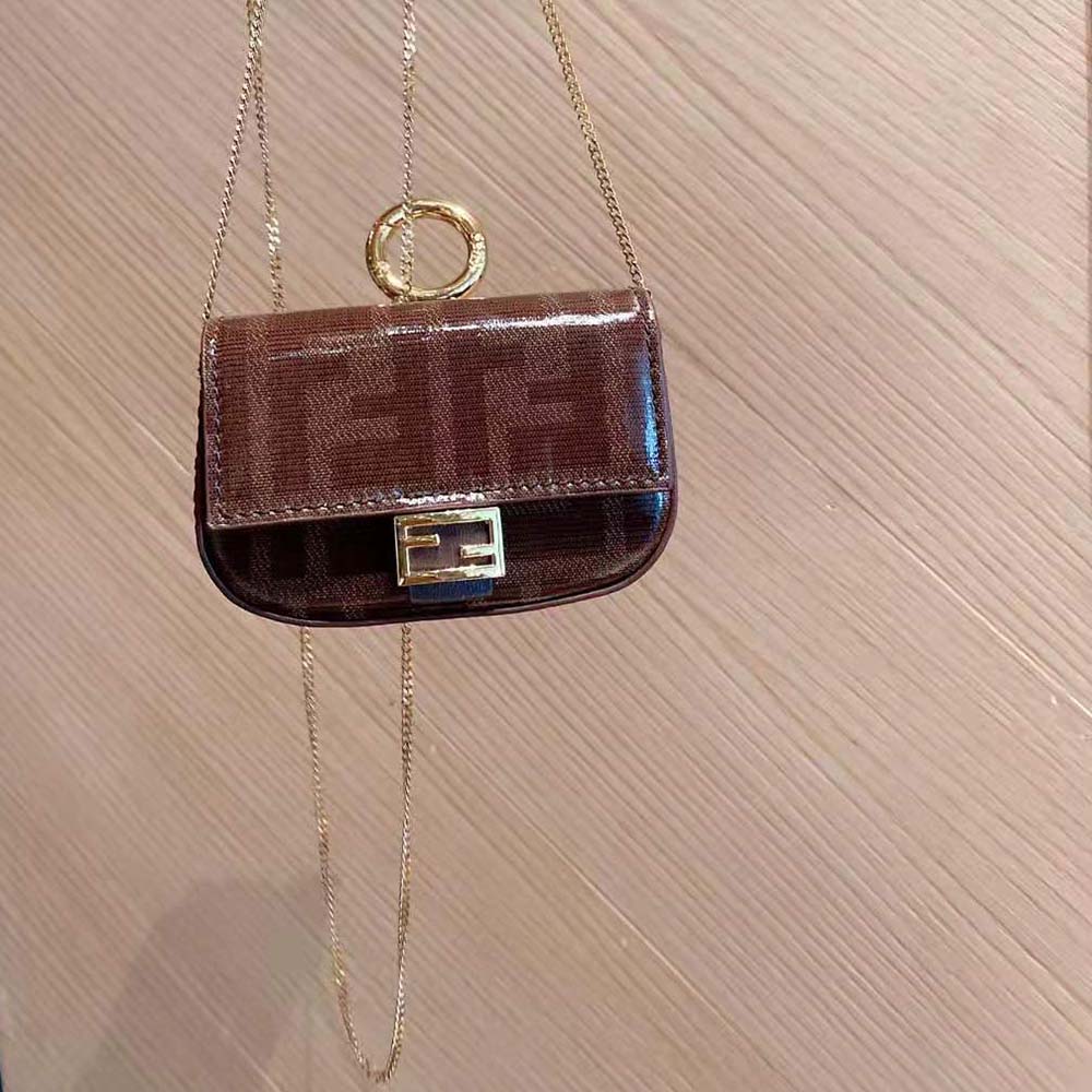 Close-up of gold-tone hardware on Fendi Women Nano Baguette Charm Fabric Charm-Brown