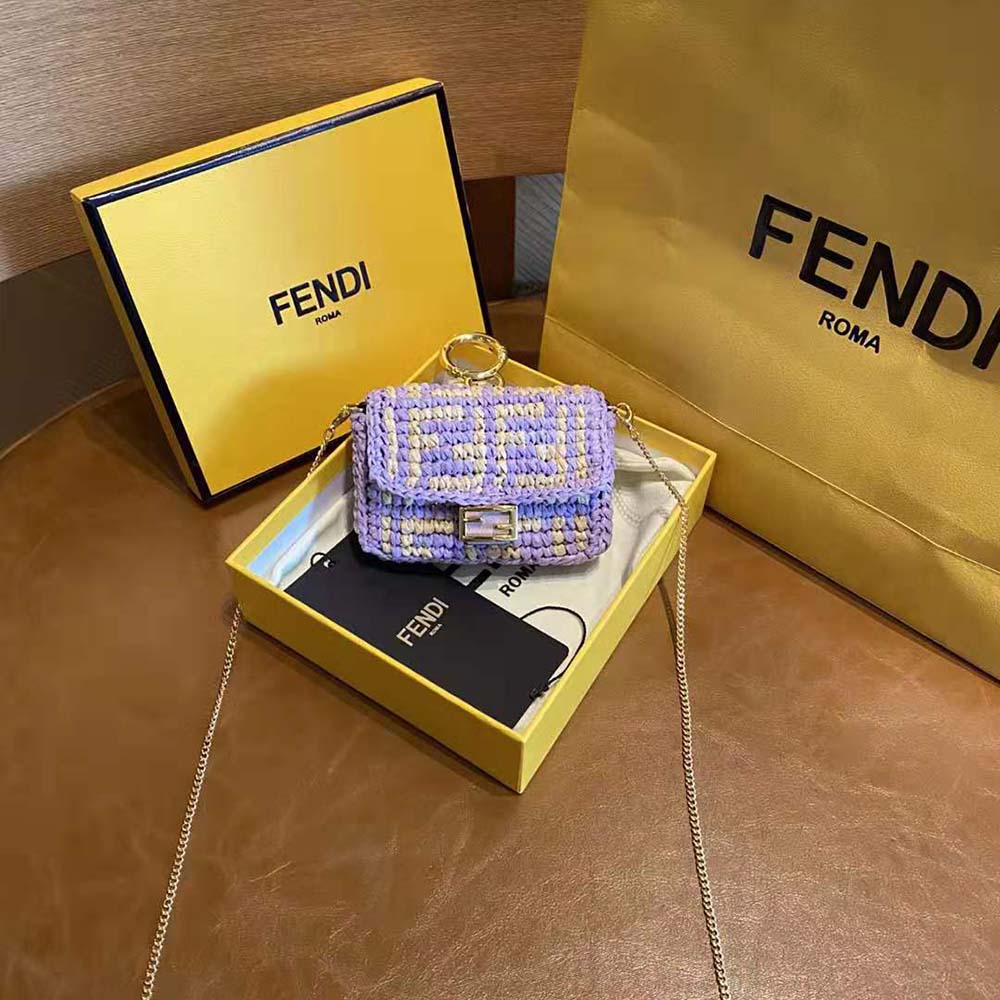 Side angle showing compact silhouette of Fendi Women Nano Baguette Charm Lilac Raffia Charm