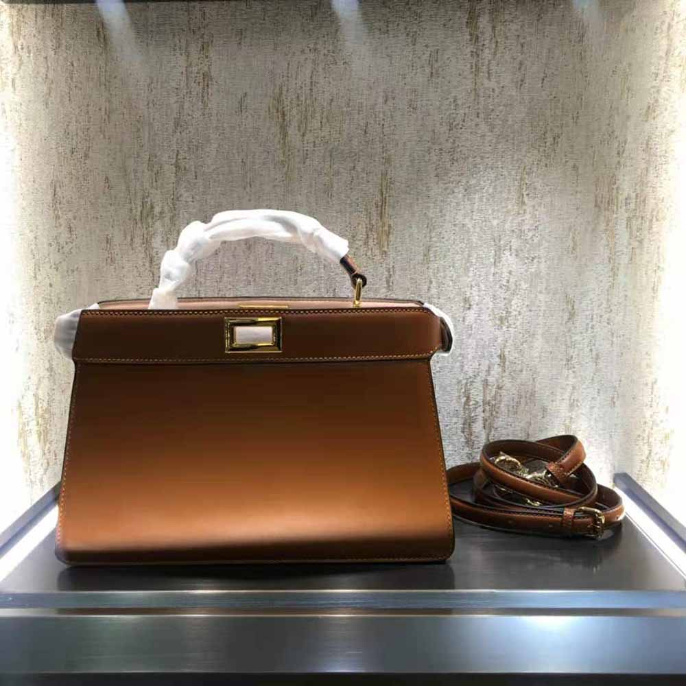 Close-up of gold hardware clasp on Fendi Peekaboo Iseeu bag in brown leather