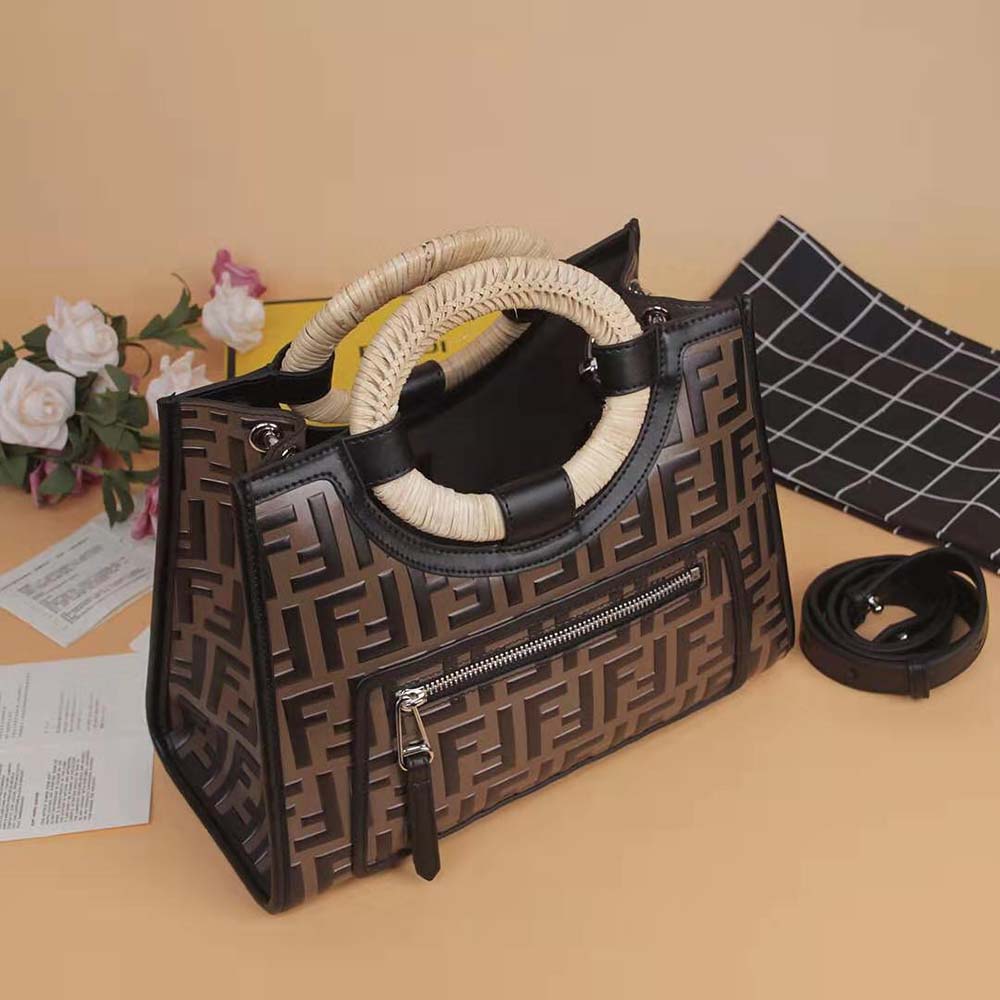 Close-up of brown leather handles and gold hardware on Fendi Women Runaway Shopper