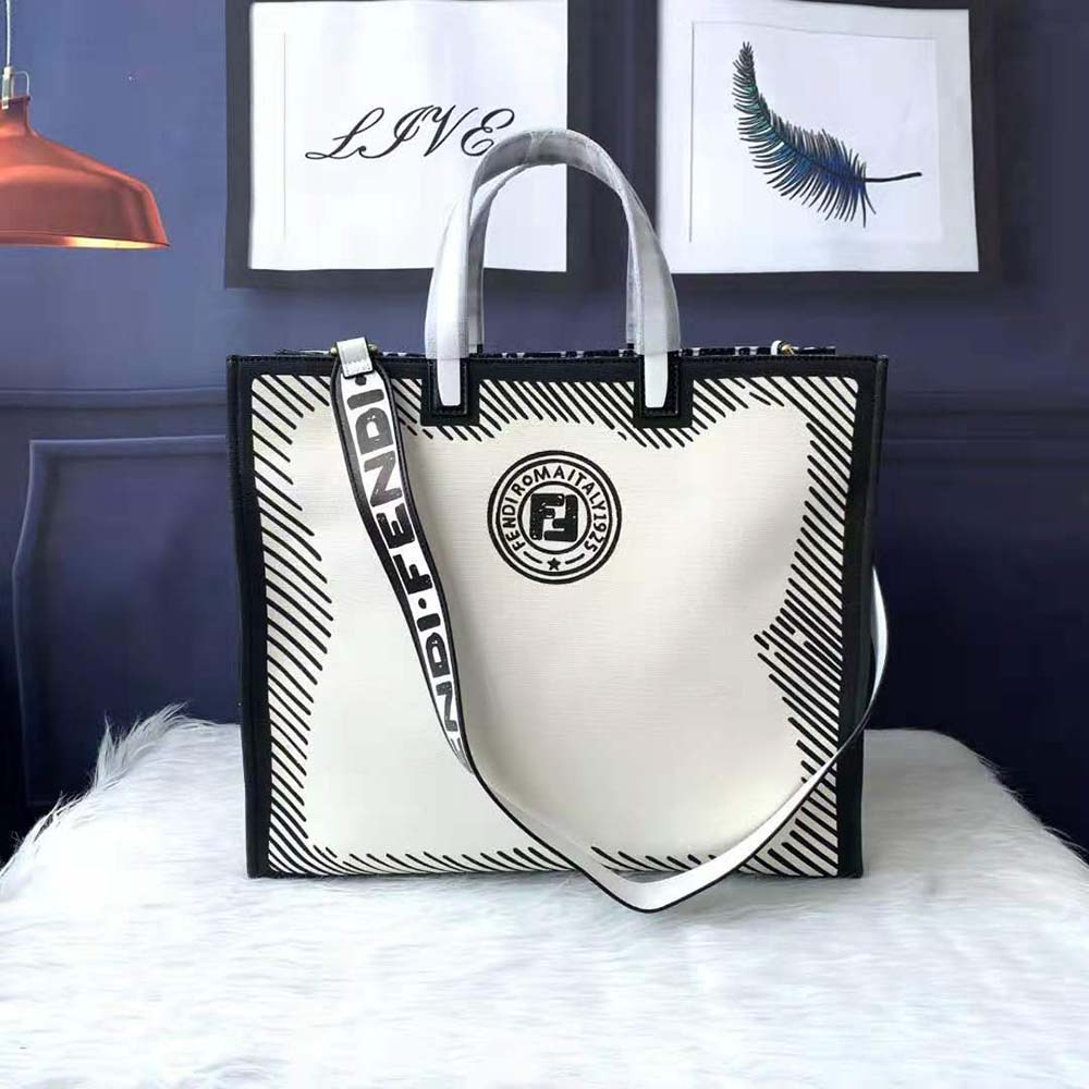 Close-up detail of glazed canvas texture and Fendi logo hardware on white bag