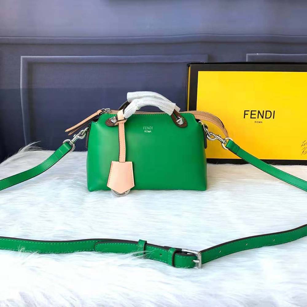 Close-up of gold Fendi logo hardware on the green leather bag