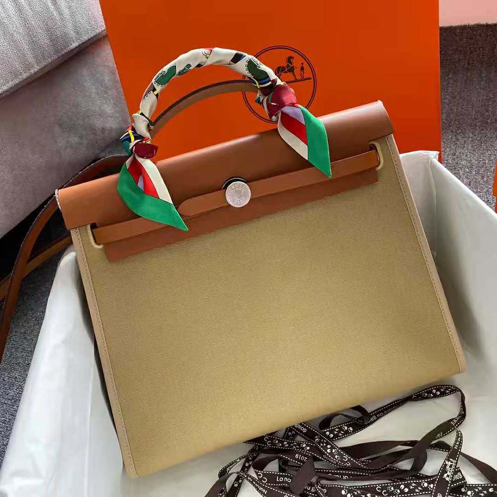 Side angle of structured silhouette of Hermes Women Herbag Zip 31 Bag-Brown