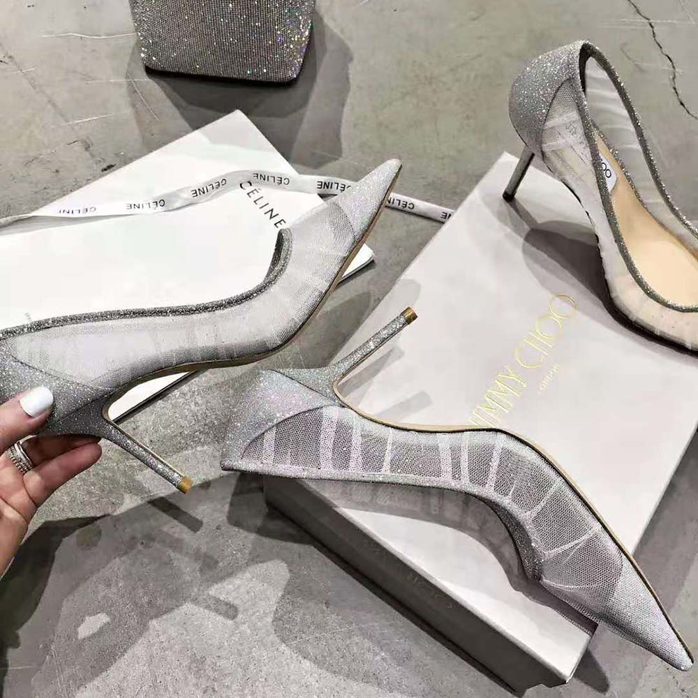 Rear angle showing signature Jimmy Choo plaque on metallic silver glitter pumps