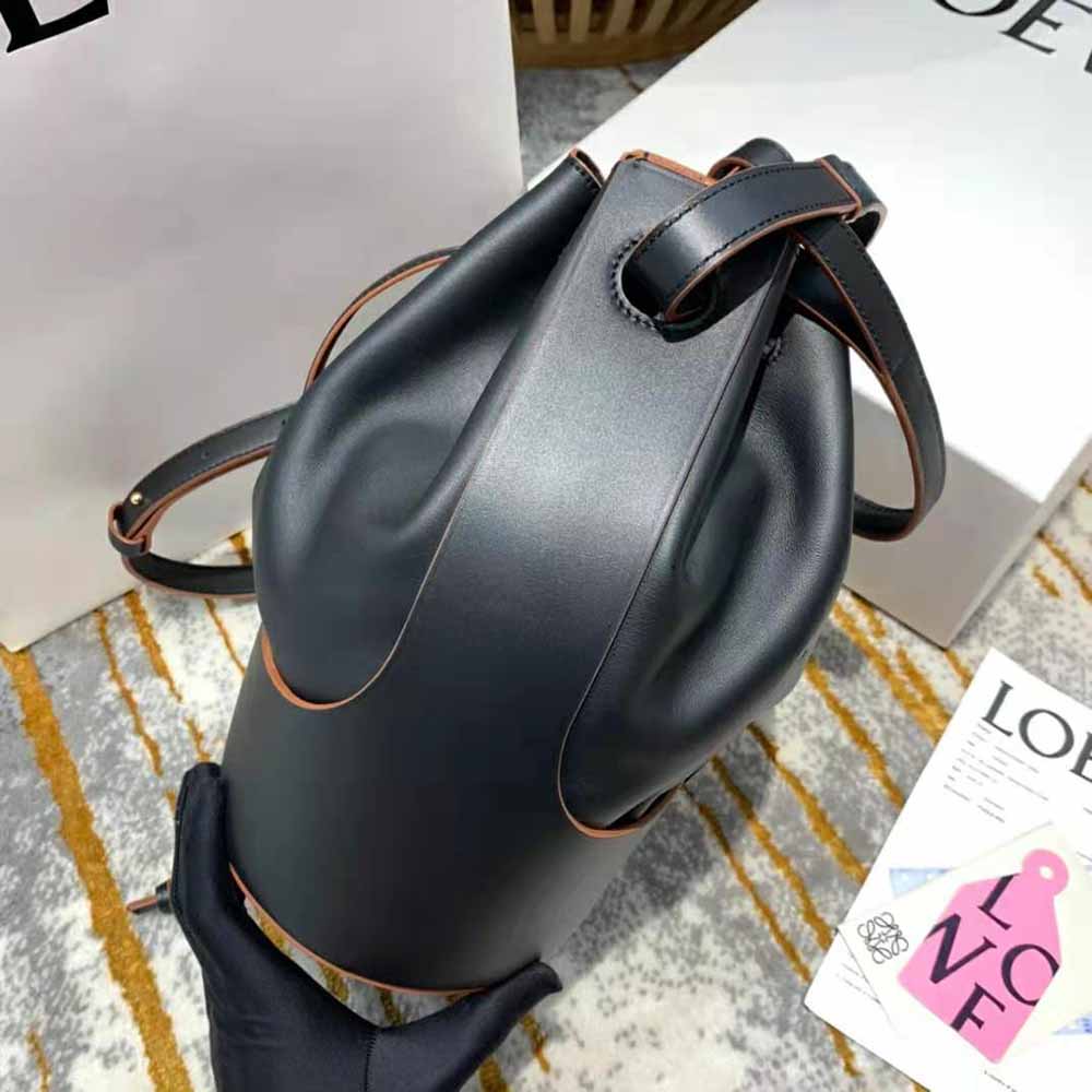 Side angle showing adjustable shoulder strap and magnetic closure of Loewe Balloon Bag