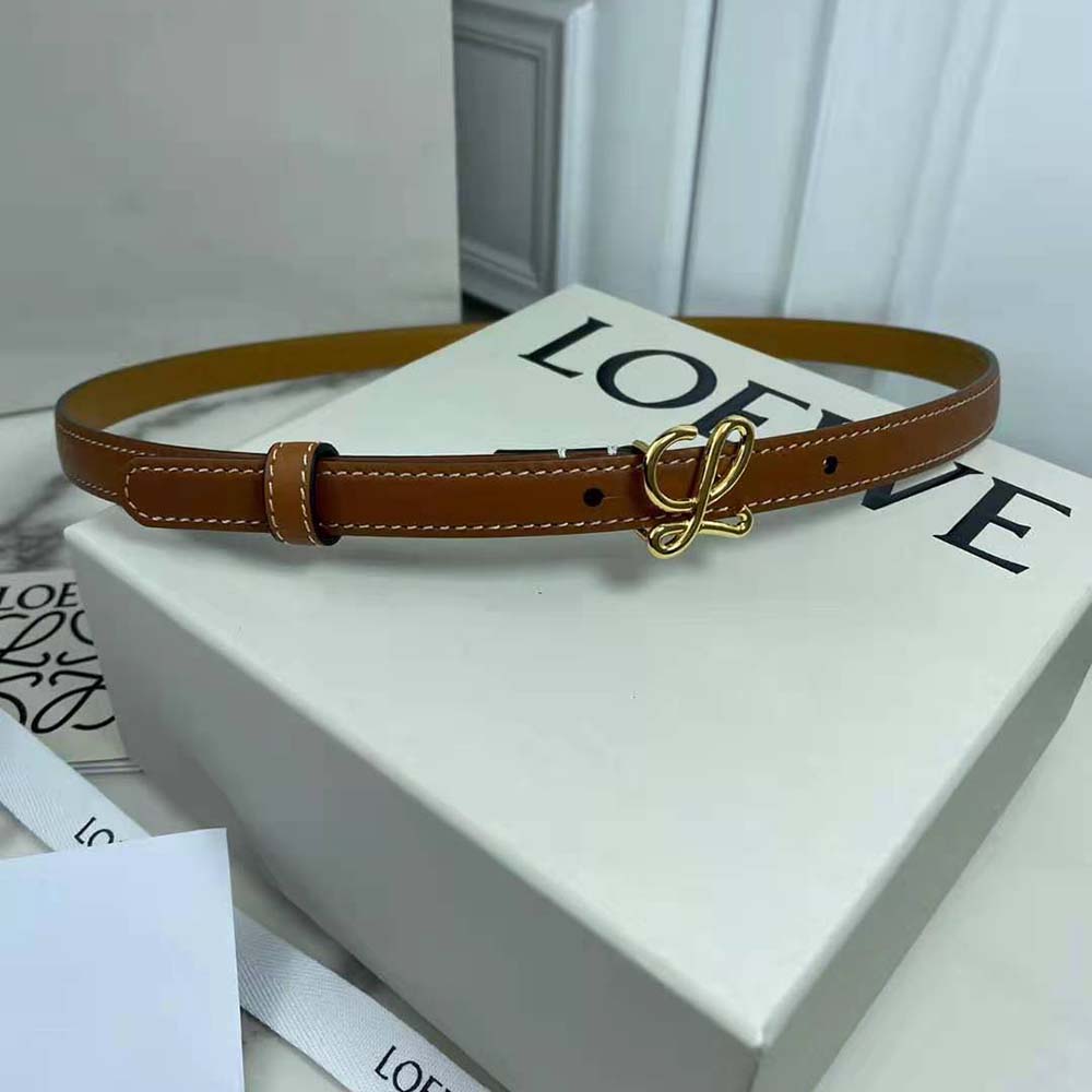 Close-up detail of Loewe embossed hardware on brown calfskin belt