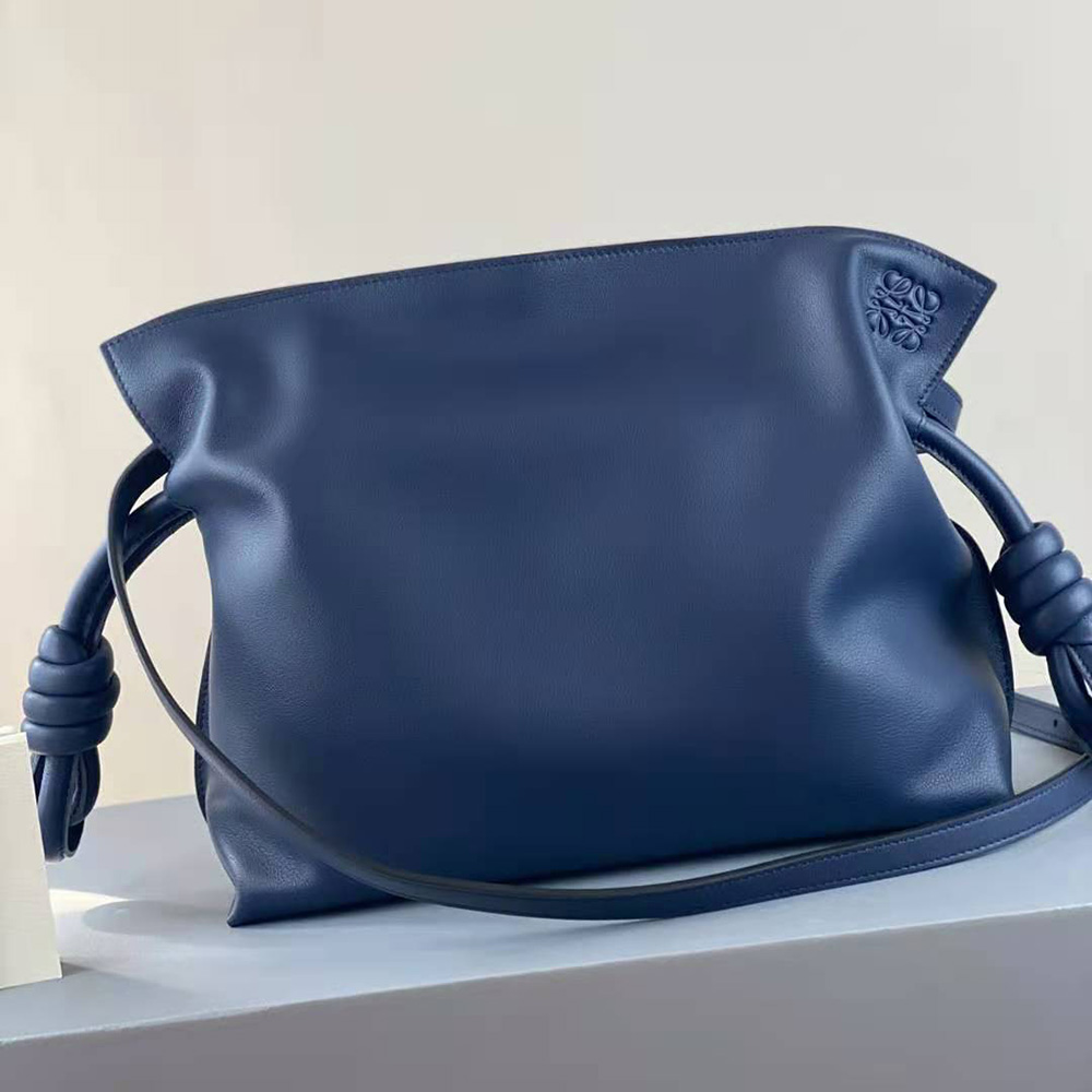 Side angle of Loewe Women Flamenco Clutch showing slim silhouette and strap