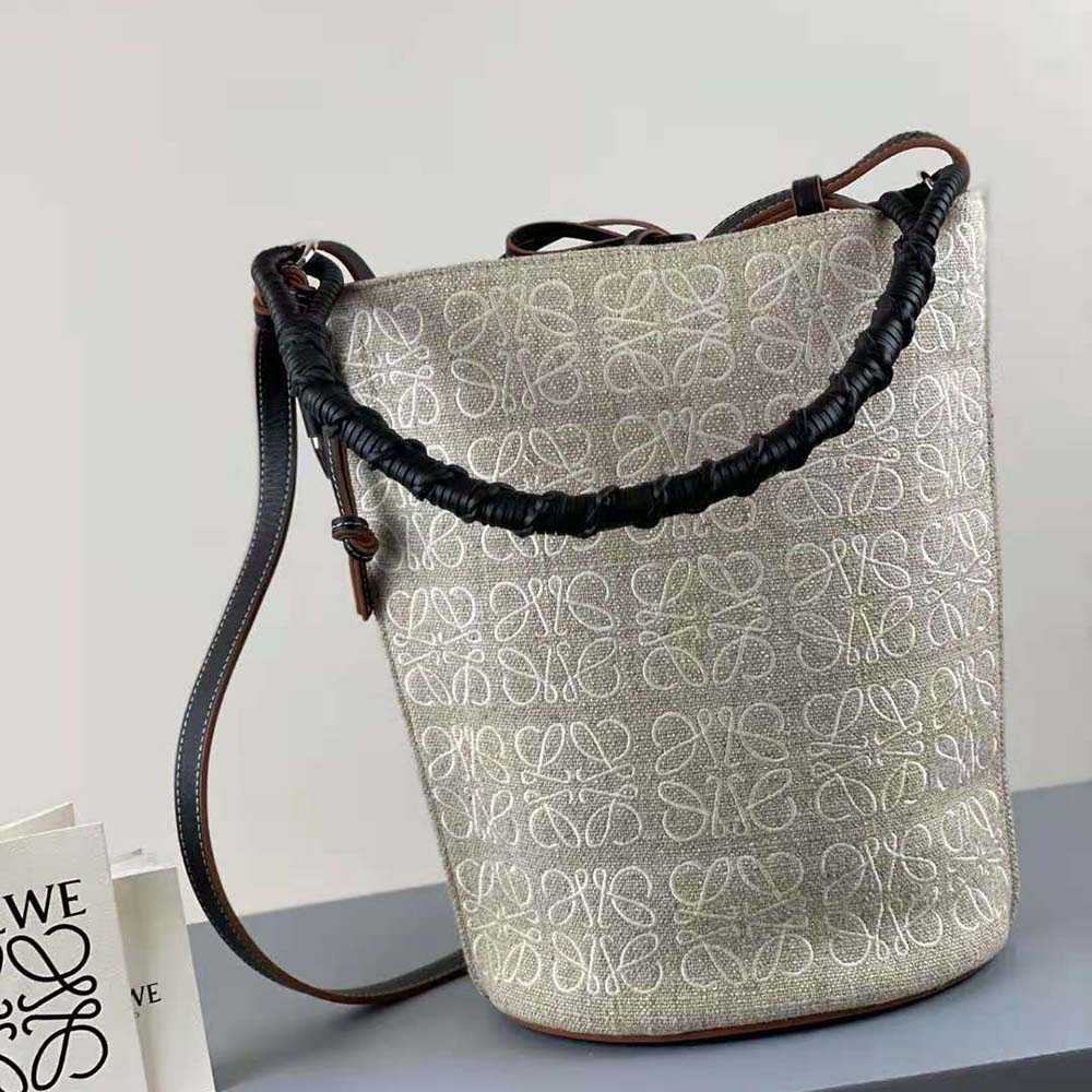 Side angle showing bucket shape and leather drawstring of Loewe Women Gate Bag