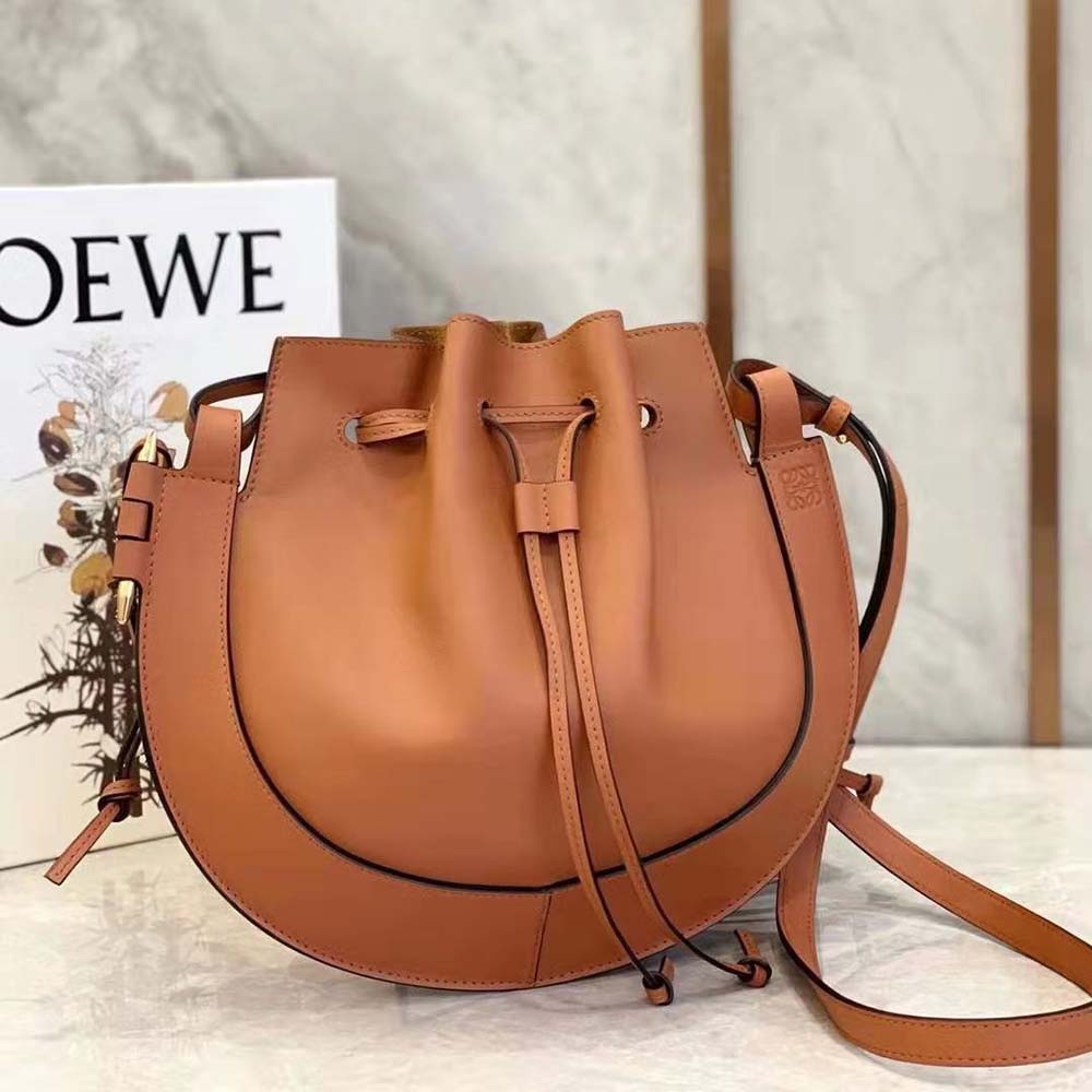 Side angle showing silhouette of Loewe Women Horseshoe Bag brown leather