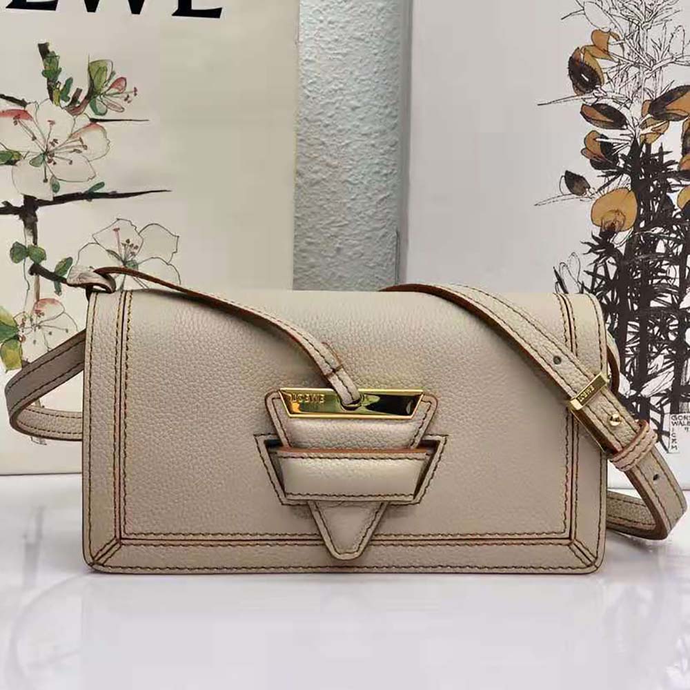 Close-up of embossed Loewe logo hardware on white Mini Barcelona bag