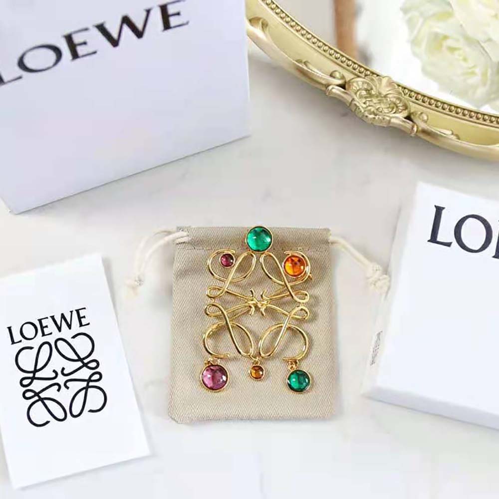 Close-up detail of Loewe Anagram logo on small gold brooch