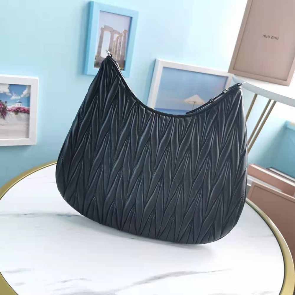 Side angle showing silver clasp and strap of Miu Miu Large Shoulder Bag Black