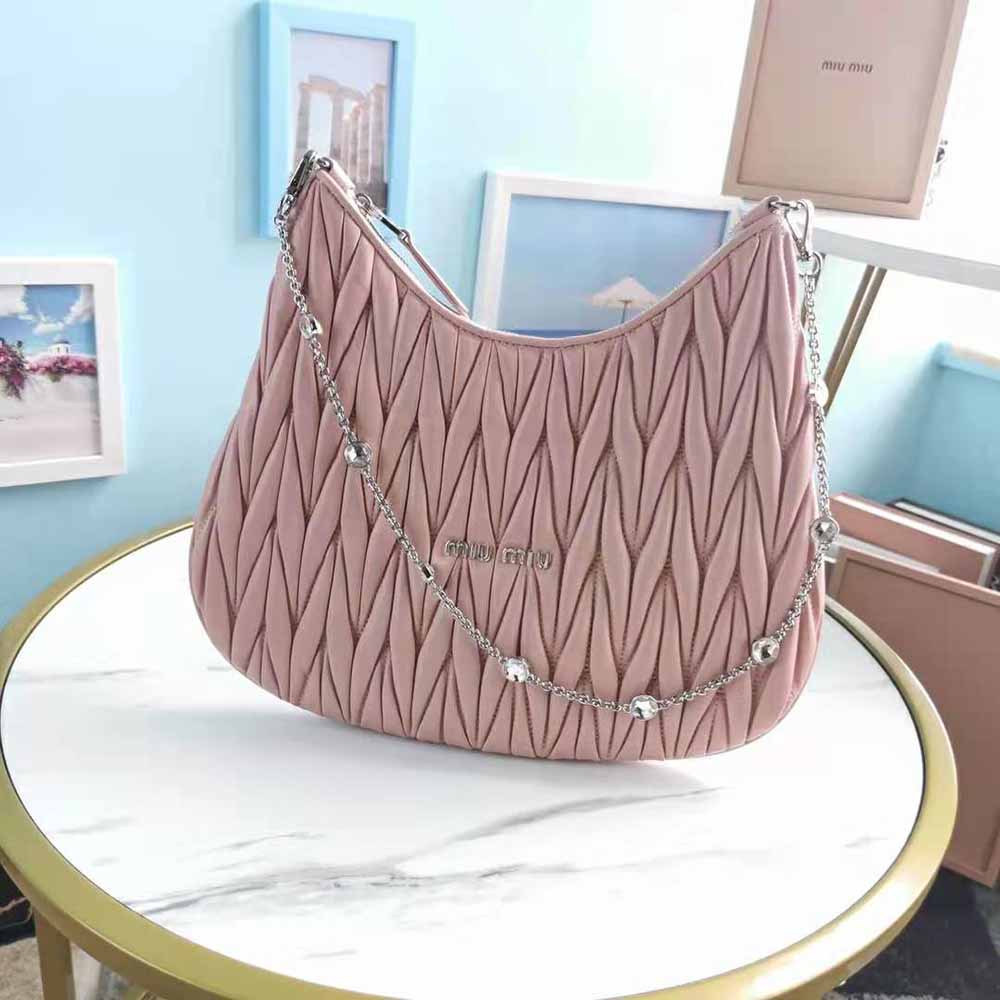 Close-up on pink matelasse quilting and silver hardware of Miu Miu bag