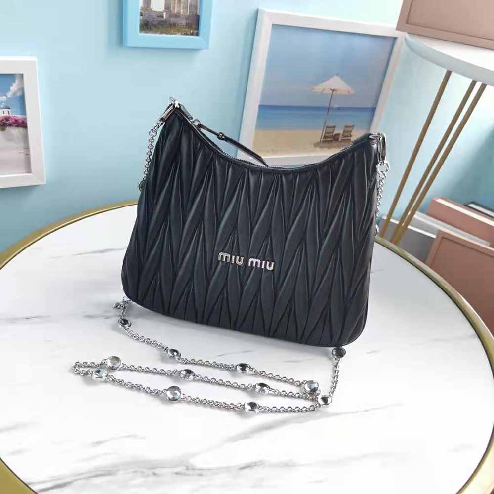 Close-up of matelassé quilting and silver hardware on Miu Miu shoulder bag