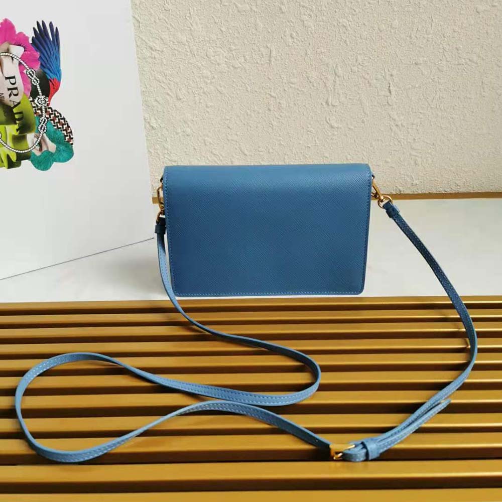 Side profile showing slim silhouette of Prada Ladies Saffiano Leather Mini Bag-Blue