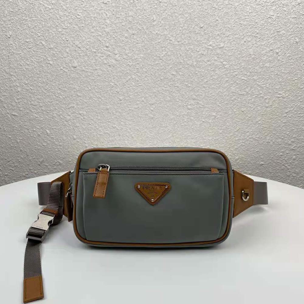 Close-up of silver Prada logo plaque on nylon belt bag