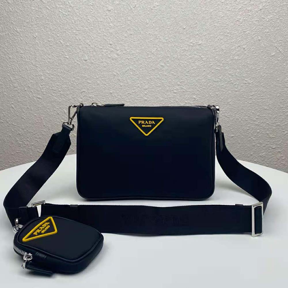 Close-up of external zipper and brushed metal Prada logo on cross-body bag