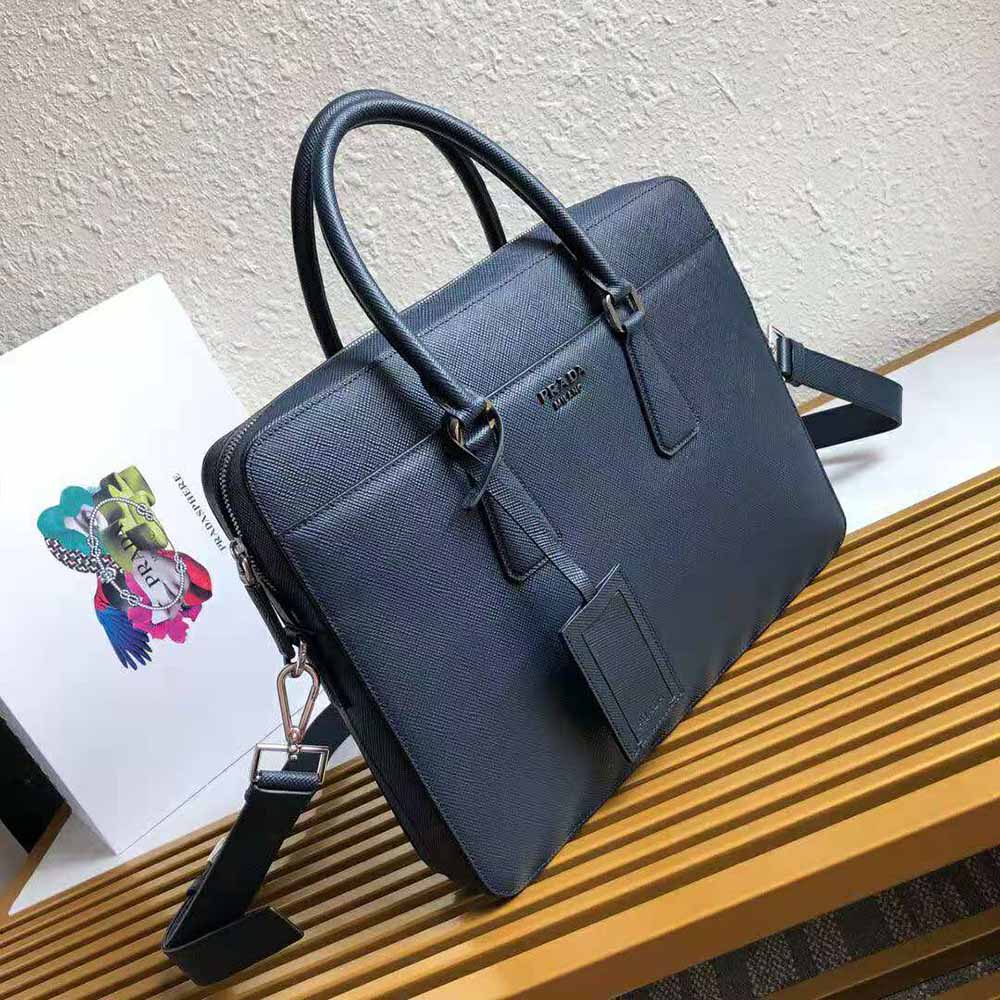 Close-up of navy Saffiano leather texture and silver hardware on Prada briefcase