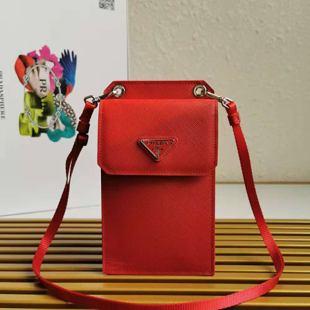 Close-up of textured Saffiano leather and silver Prada logo on red smartphone case