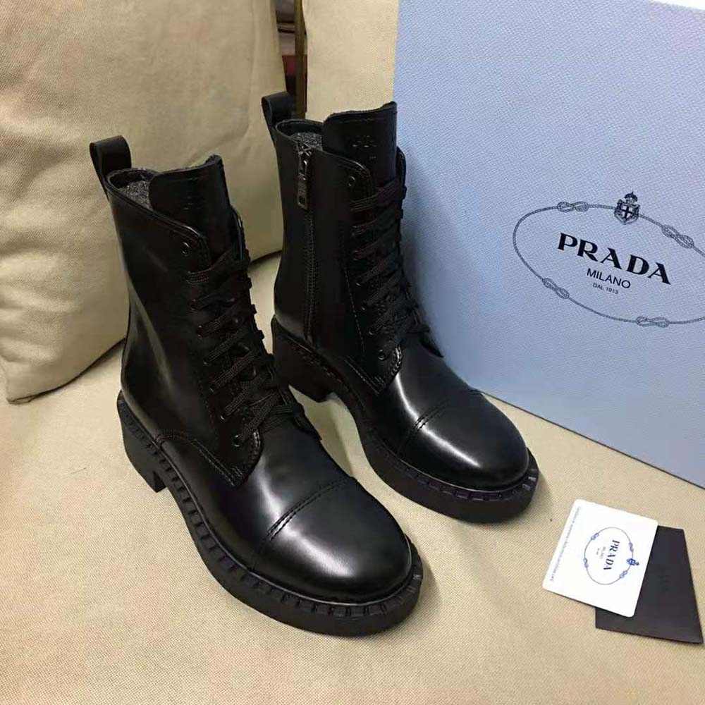 Close-up detail of lace and brushed leather texture on Prada booties