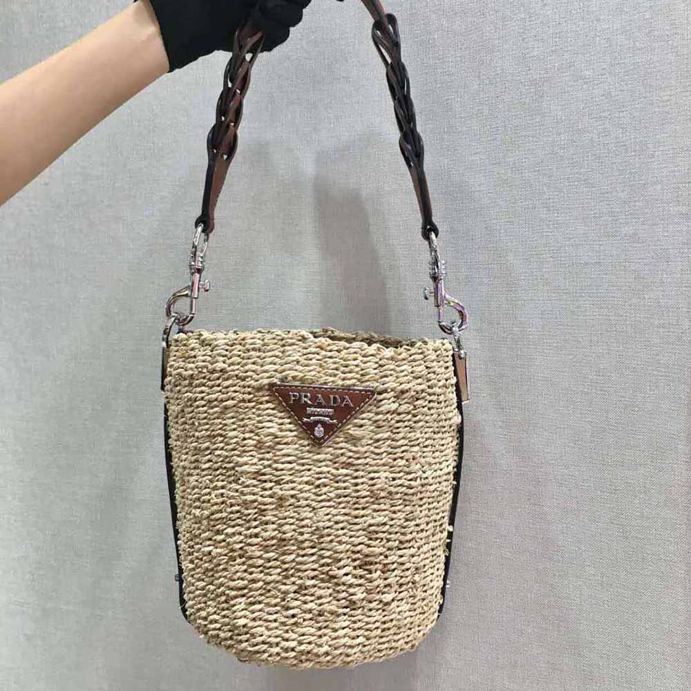 Close-up of drawstring closure and corn husk texture on Prada bucket bag