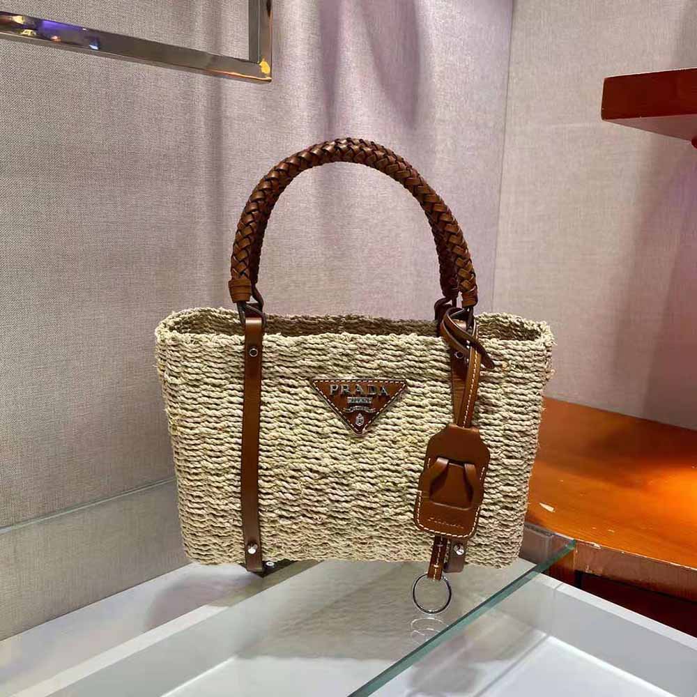 Side angle showing leather handles and zipper closure of Prada Tote