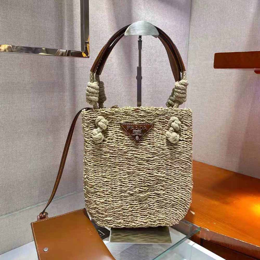 Side angle showing brown leather handles and gold hardware detail