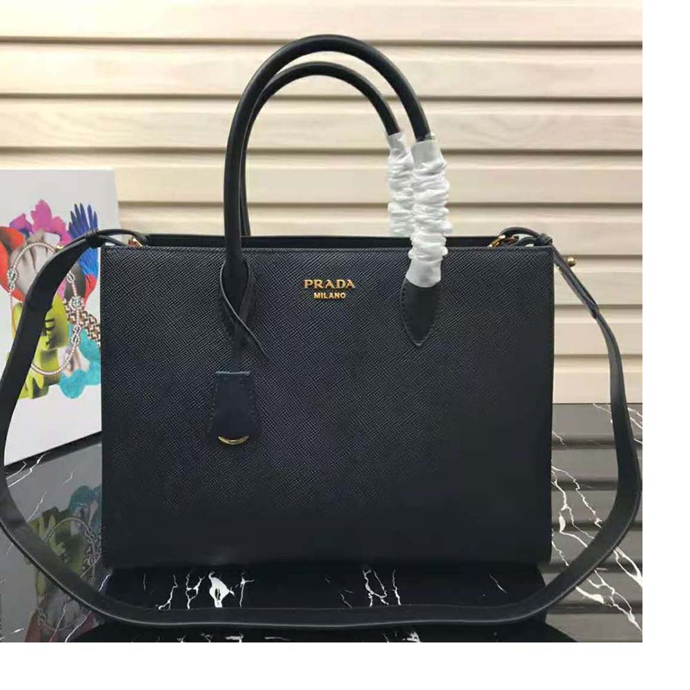 Close-up of gold-tone hardware and Prada logo on black saffiano leather handbag