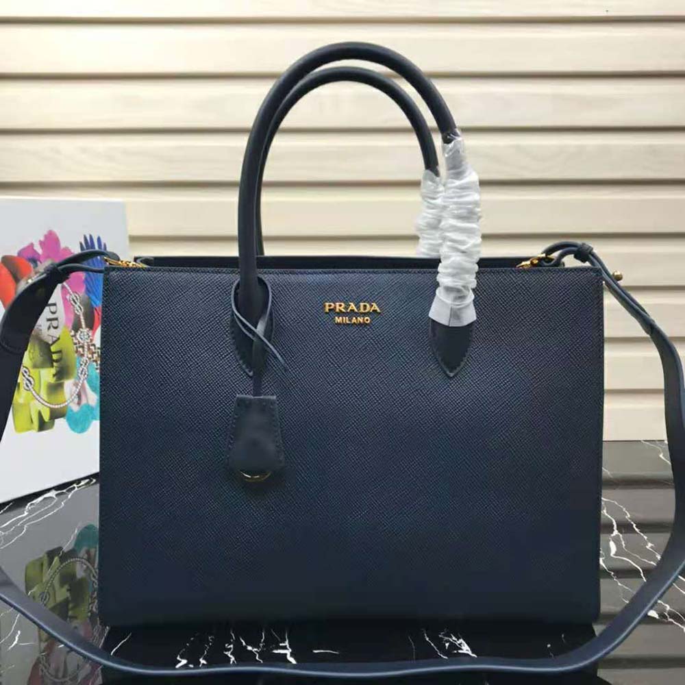 Close-up detail of navy Saffiano leather and Prada logo on handbag