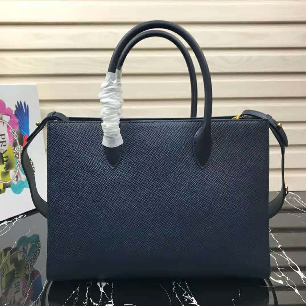 Side angle showing structured silhouette of Prada Women Large Saffiano Leather Handbag-Navy