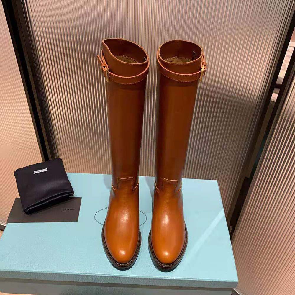 Top view showing smooth leather and side zipper of Prada boots