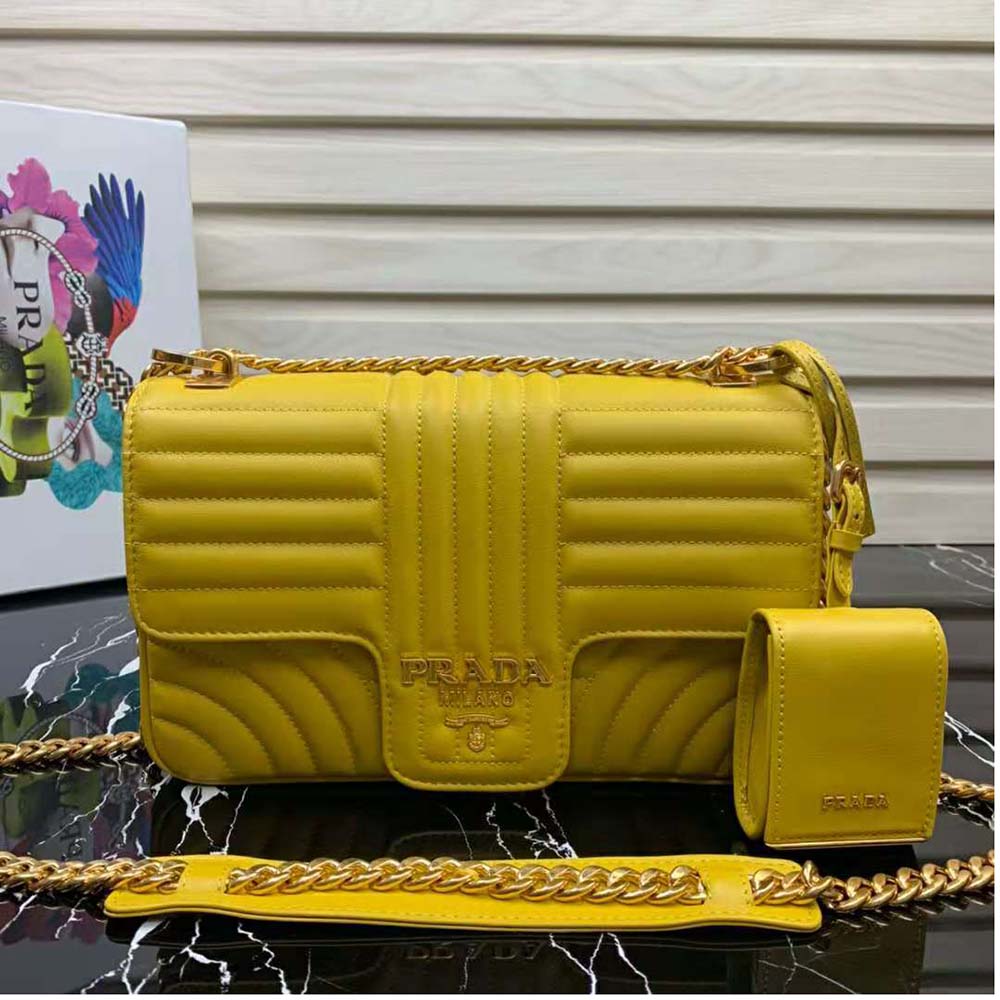 Close-up of yellow leather texture and gold Prada logo on Prada Diagramme Bag