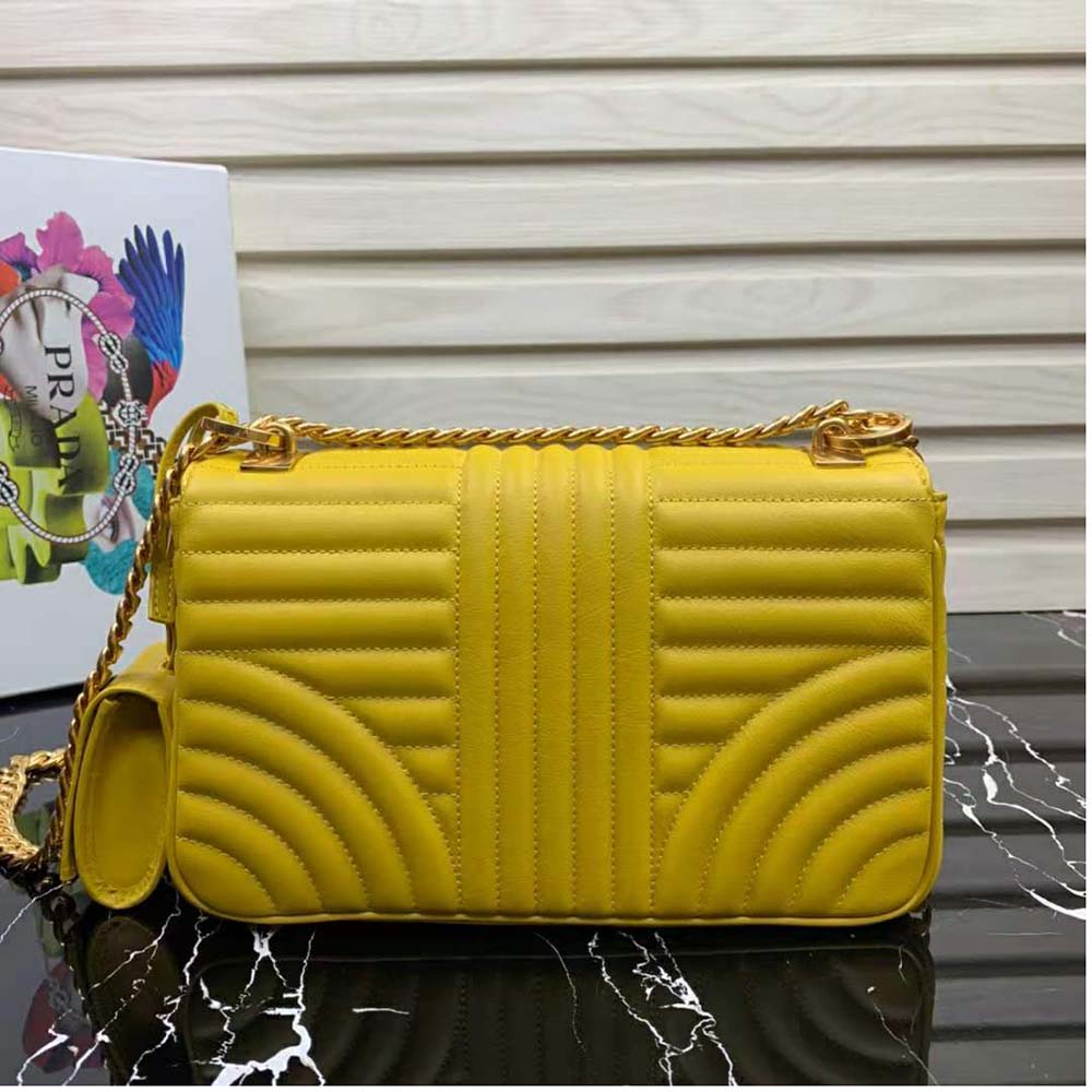 Side angle showing adjustable strap and chevron quilting on Prada Women Medium Leather Prada Diagramme Bag-Yellow