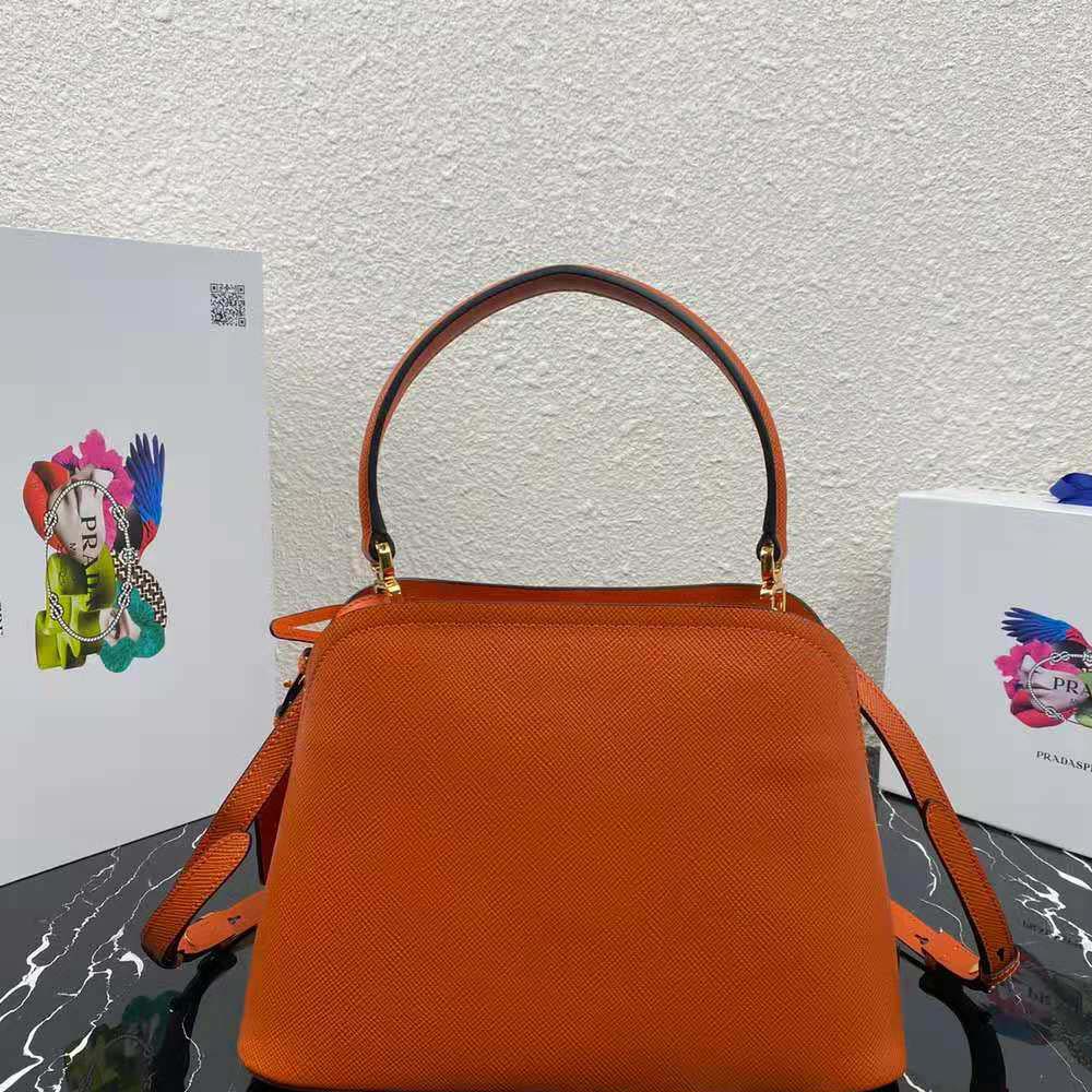 Side angle showing structured silhouette of Prada Women Medium Saffiano Leather Prada Matinee Bag-Orange