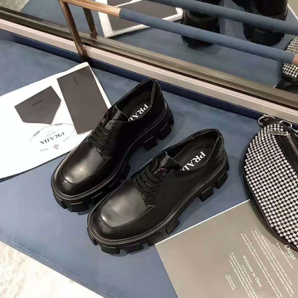 Close-up on brushed calf leather texture and lacing of Prada Monolith shoes