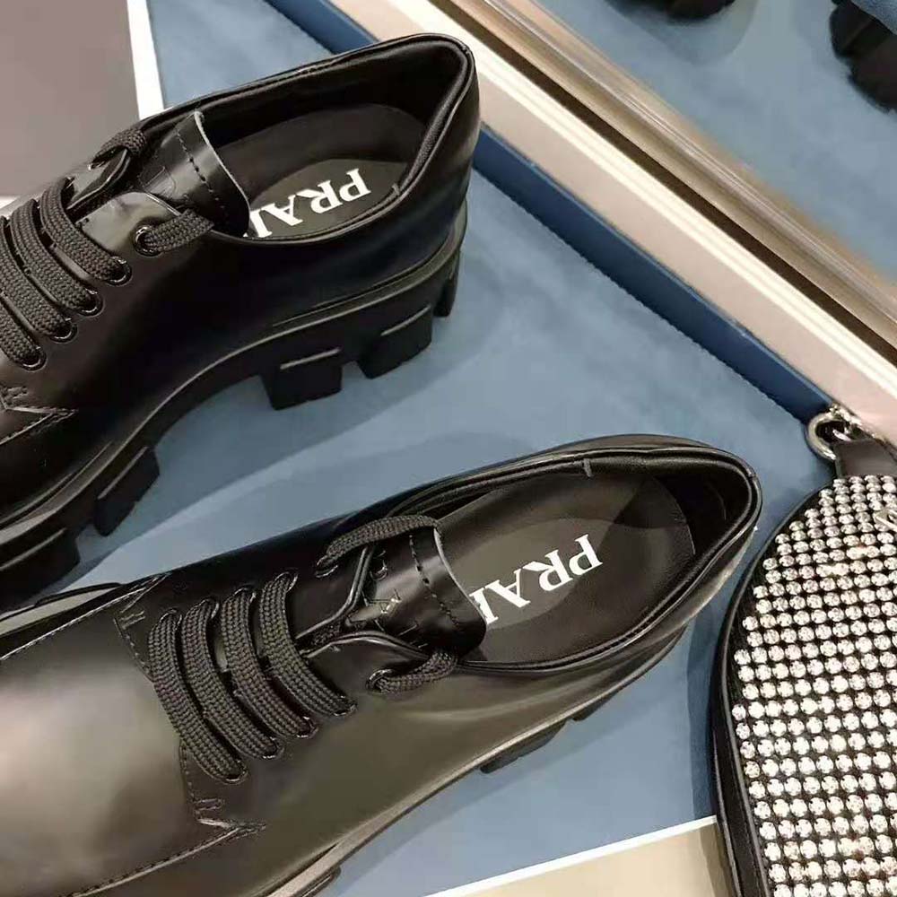 View of black monolith rubber sole on Prada Women Monolith lace-up shoes