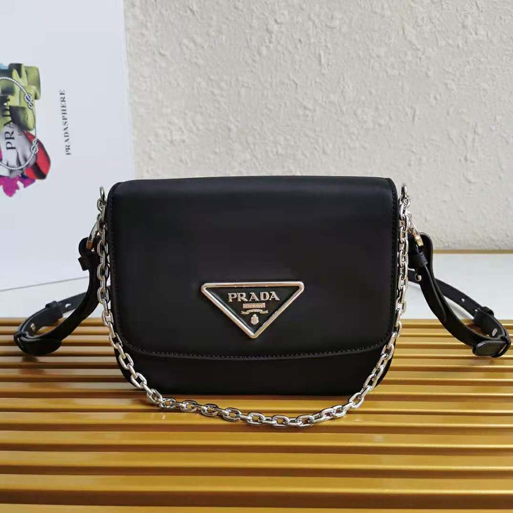 Close-up of silver-tone Prada hardware on nylon and leather bag