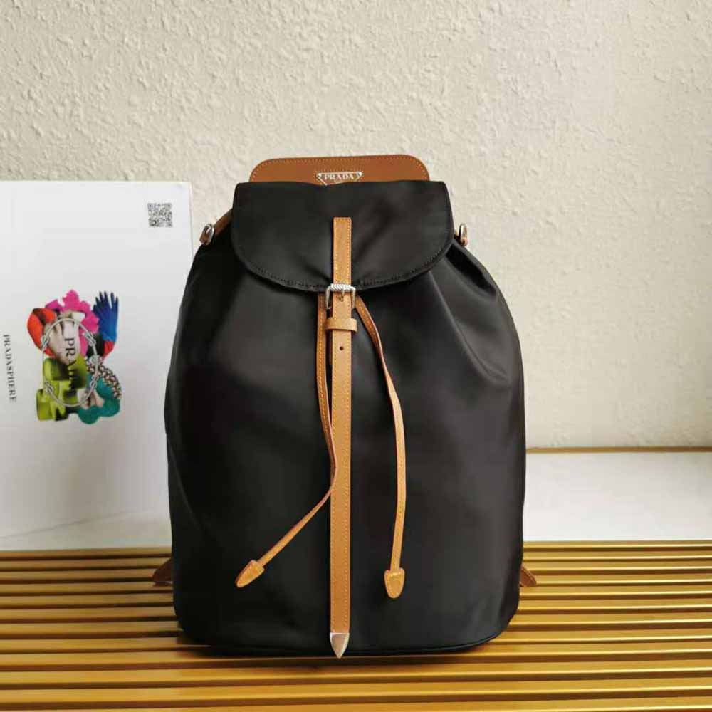 Close-up of gold-tone hardware and Prada logo on the brown backpack