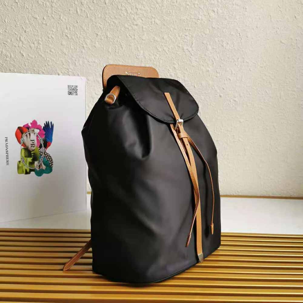 Side angle showing structured silhouette of Prada Women Nylon and Saffiano Leather Backpack-Brown