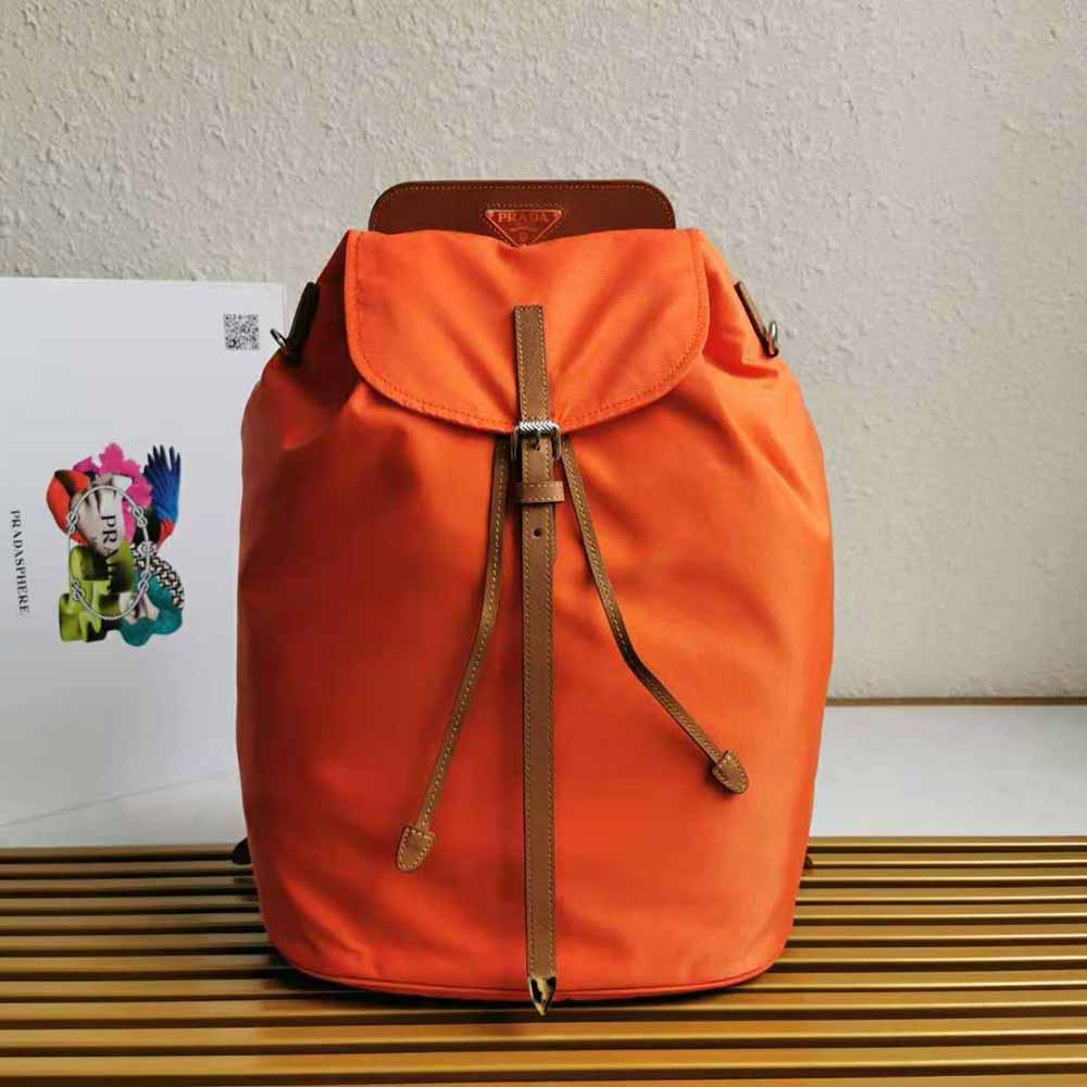 Close-up of saffiano leather and Prada logo on orange backpack