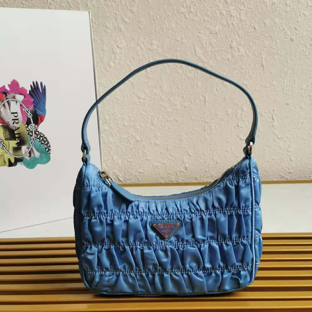 Close-up of blue saffiano leather trim and silver hardware on Prada mini bag