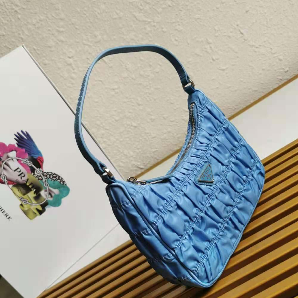 Side angle showing adjustable strap on Prada Women Nylon and Saffiano Leather Mmini Bag-Blue