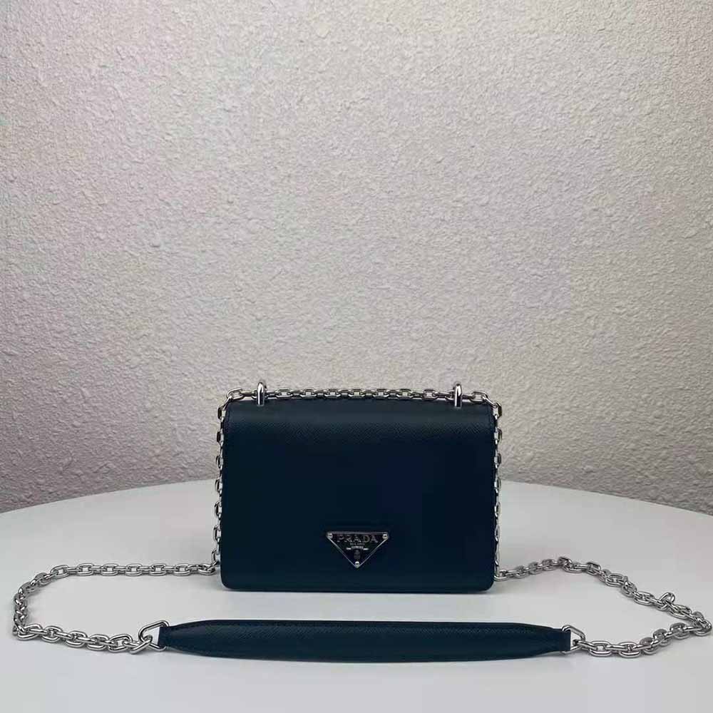 Close-up of silver-tone logo on Prada Women Nylon and Saffiano Leather Shoulder Bag-Black