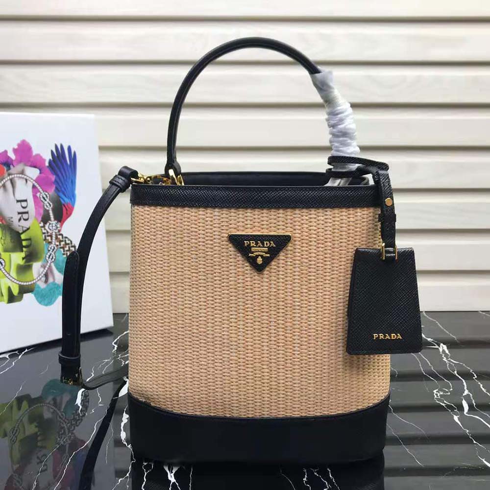 Close-up detail of gold-tone hardware on Prada Panier Medium Straw Bag-Black