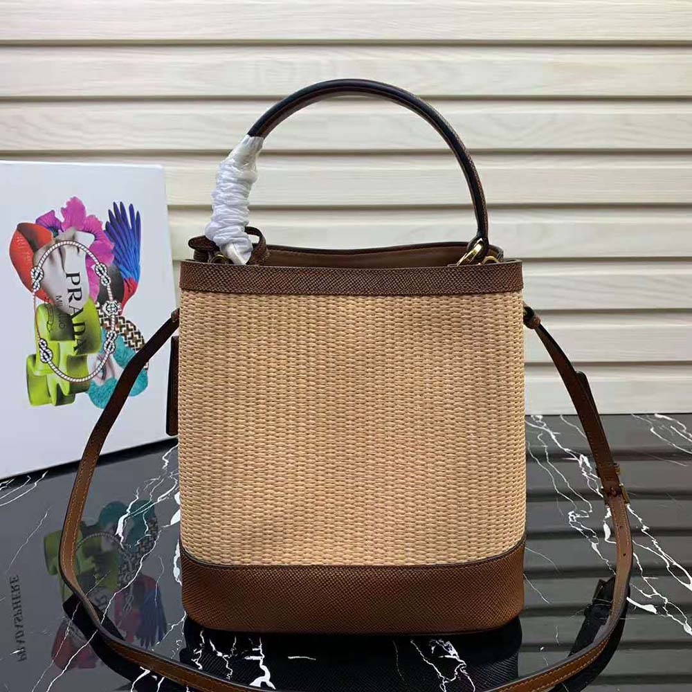 Side angle showing woven straw texture on Prada Panier Medium Bag