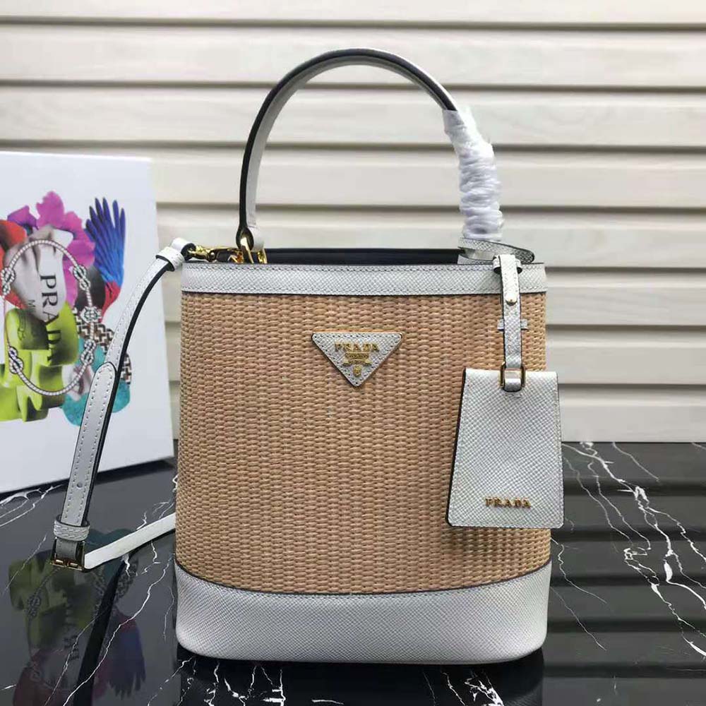 Close-up of white leather trim and gold hardware on Prada Panier bag