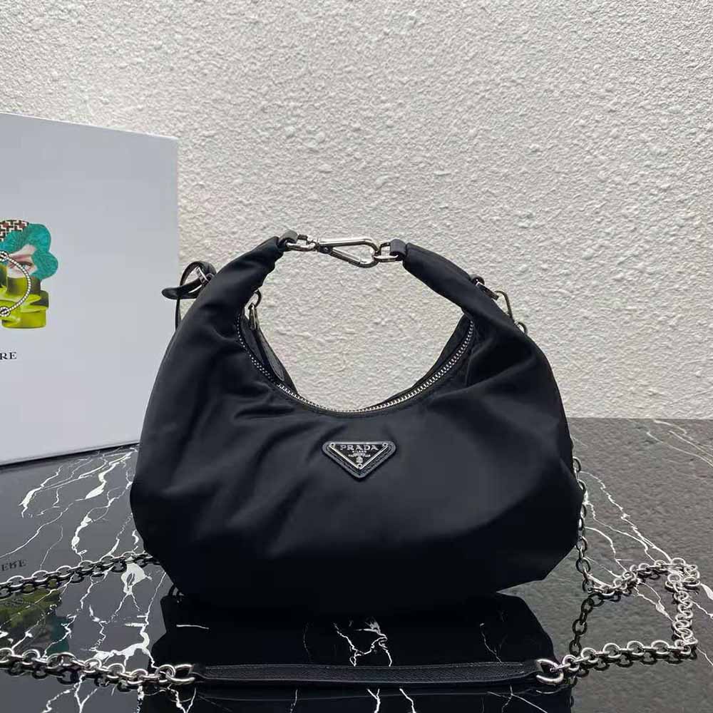Close-up of silver-tone triangle logo on Prada Women Re-Edition 2006 Nylon Bag-Black